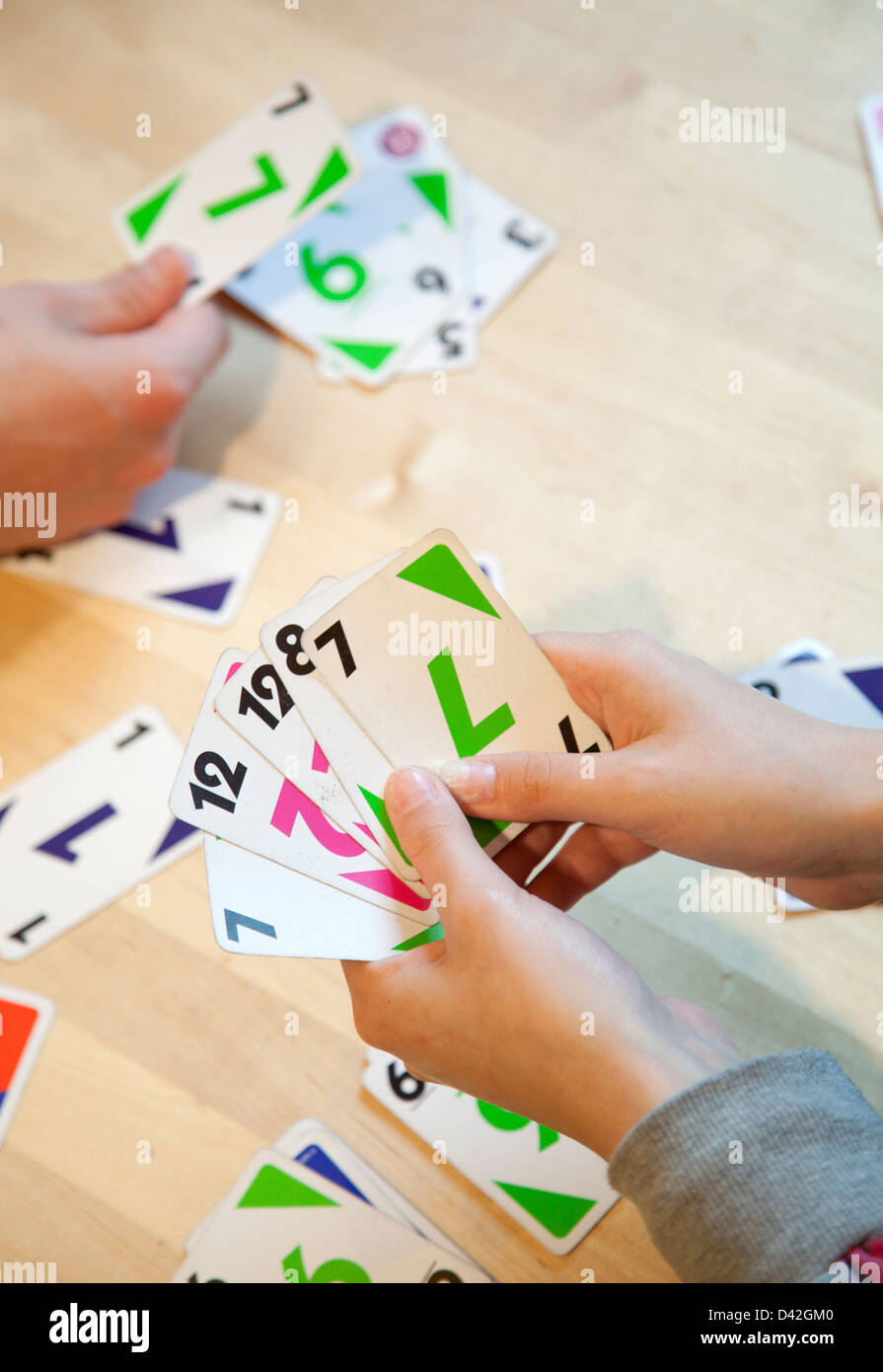 Uno cards in hand, card game Stock Photo by ©Egor_1896 239236398