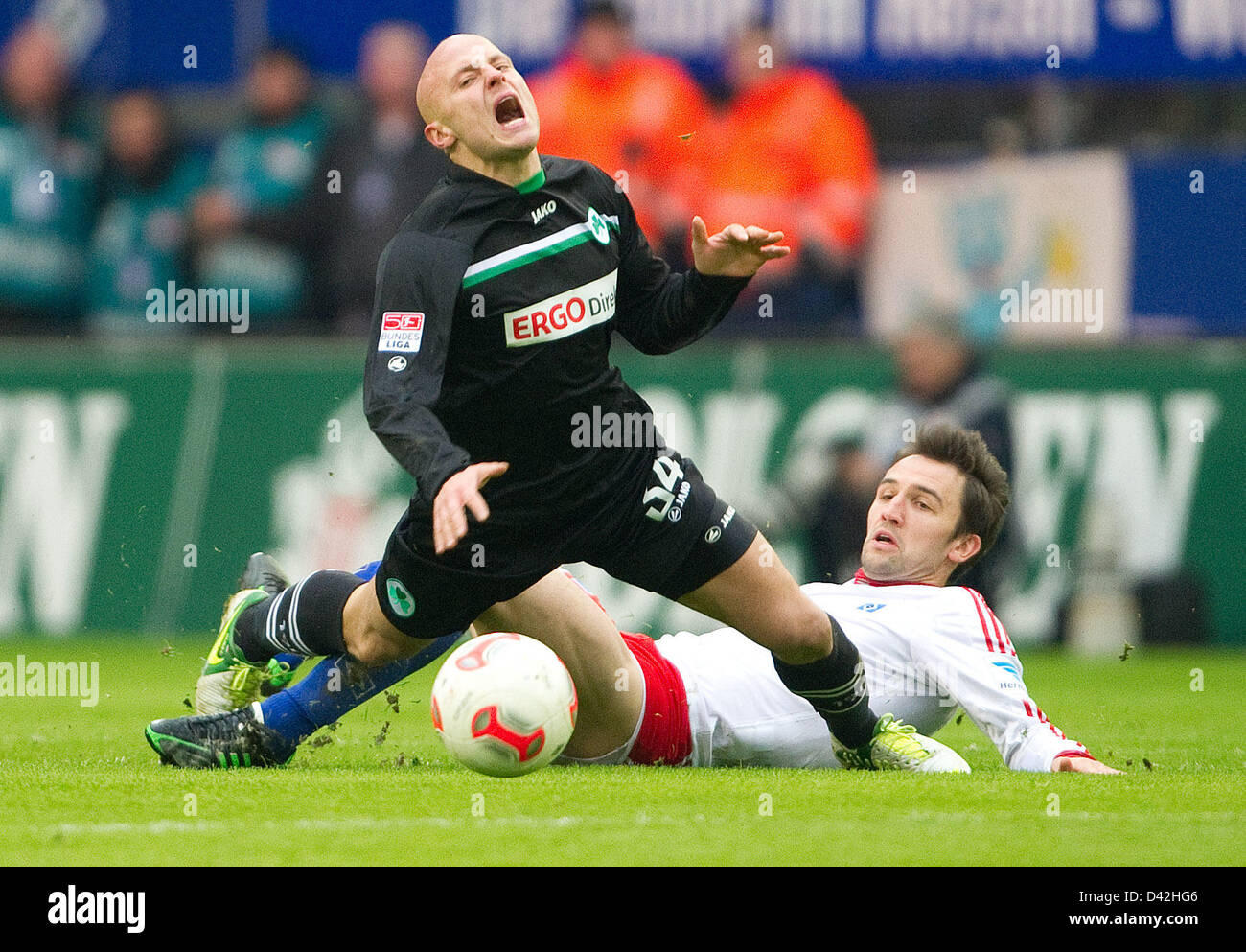 Fuerth's Jozsef Varga (F) and Hamburg's Milan Badelj vie for the ball during the match Hamburger SV - SpVgg Greuther Fuerth in the Imtech Arena in Hamburg, Germany, 02 March 2013. PHOTO: AXEL HEIMKEN   (ATTENTION: EMBARGO CONDITIONS! The DFL permits the further utilisation of up to 15 pictures only (no sequntial pictures or video-similar series of pictures allowed) via the internet and online media during the match (including halftime), taken from inside the stadium and/or prior to the start of the match. The DFL permits the unrestricted transmission of digitised recordings during the match ex Stock Photo