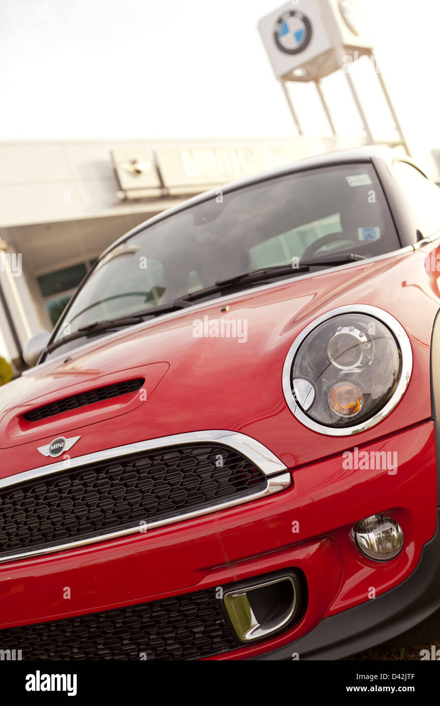 A new 2012 red Mini Cooper S model car in front of a BMW dealership in Halifax, Nova Scotia, Canada. Stock Photo