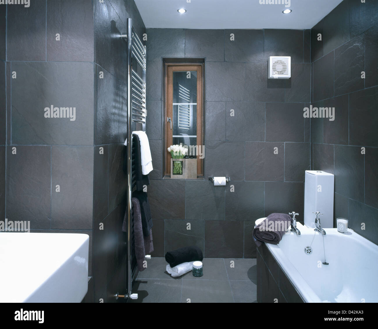 Charcoal gray slate tiled walls in modern townhouse bathroom with