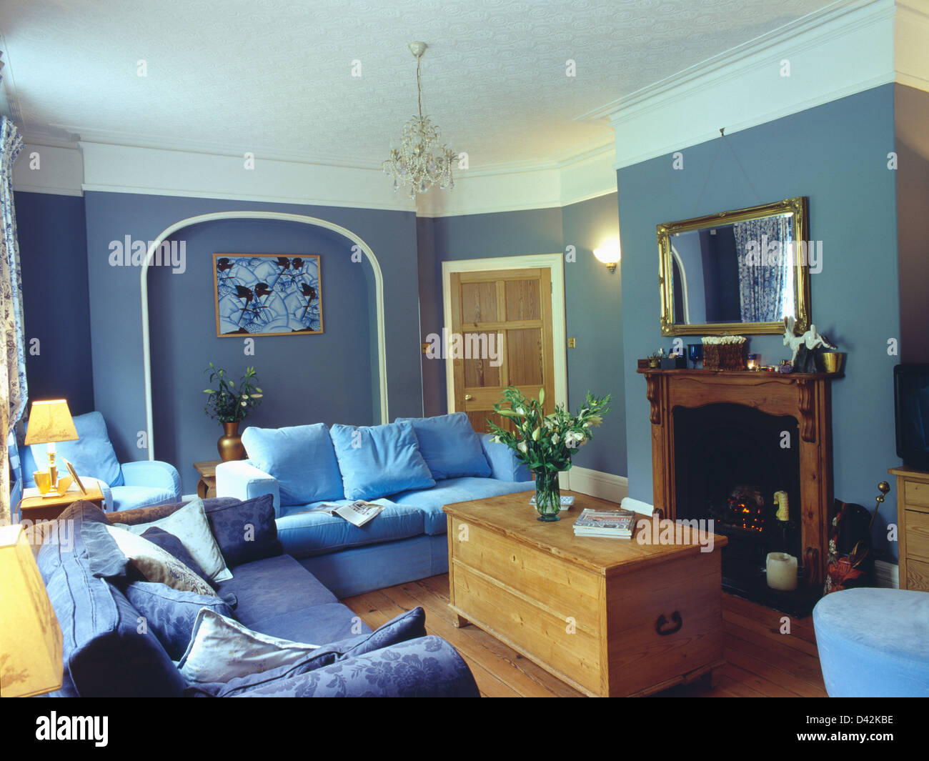 Pine Chest In Front Of Fireplace In Blue Living Room With