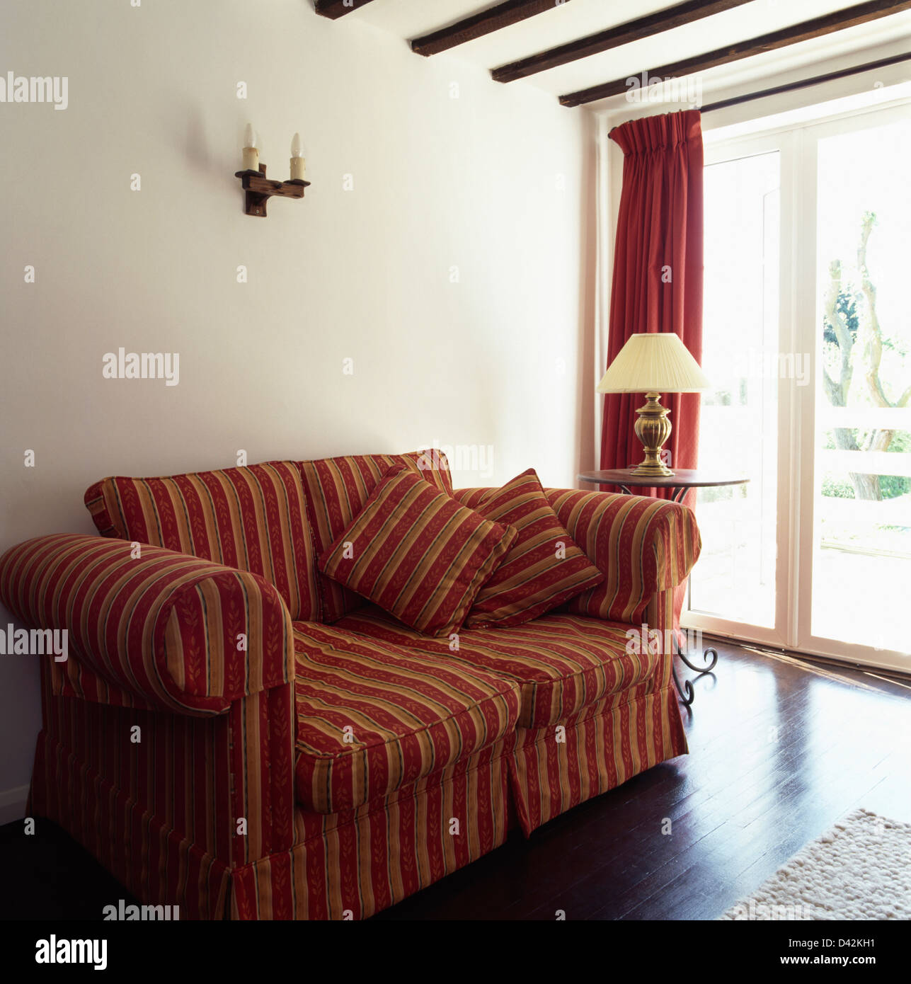 Red Pink Striped Loose Cover On Sofa In Simple White Living Room