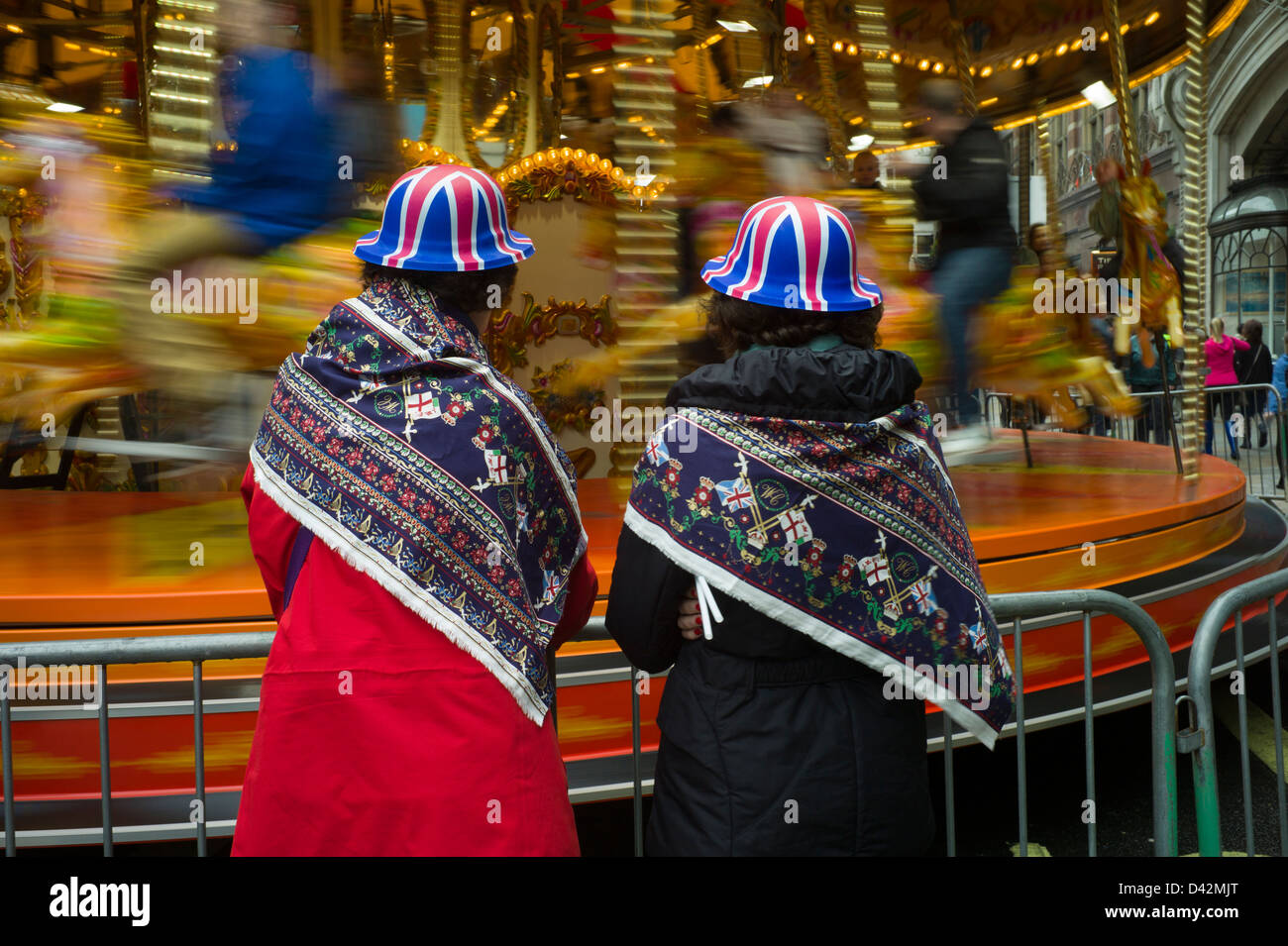Queens Jubilee Piccadilly Street Party, London England, June 2012. Twins in matching hats enjoying the street party carousel. Stock Photo