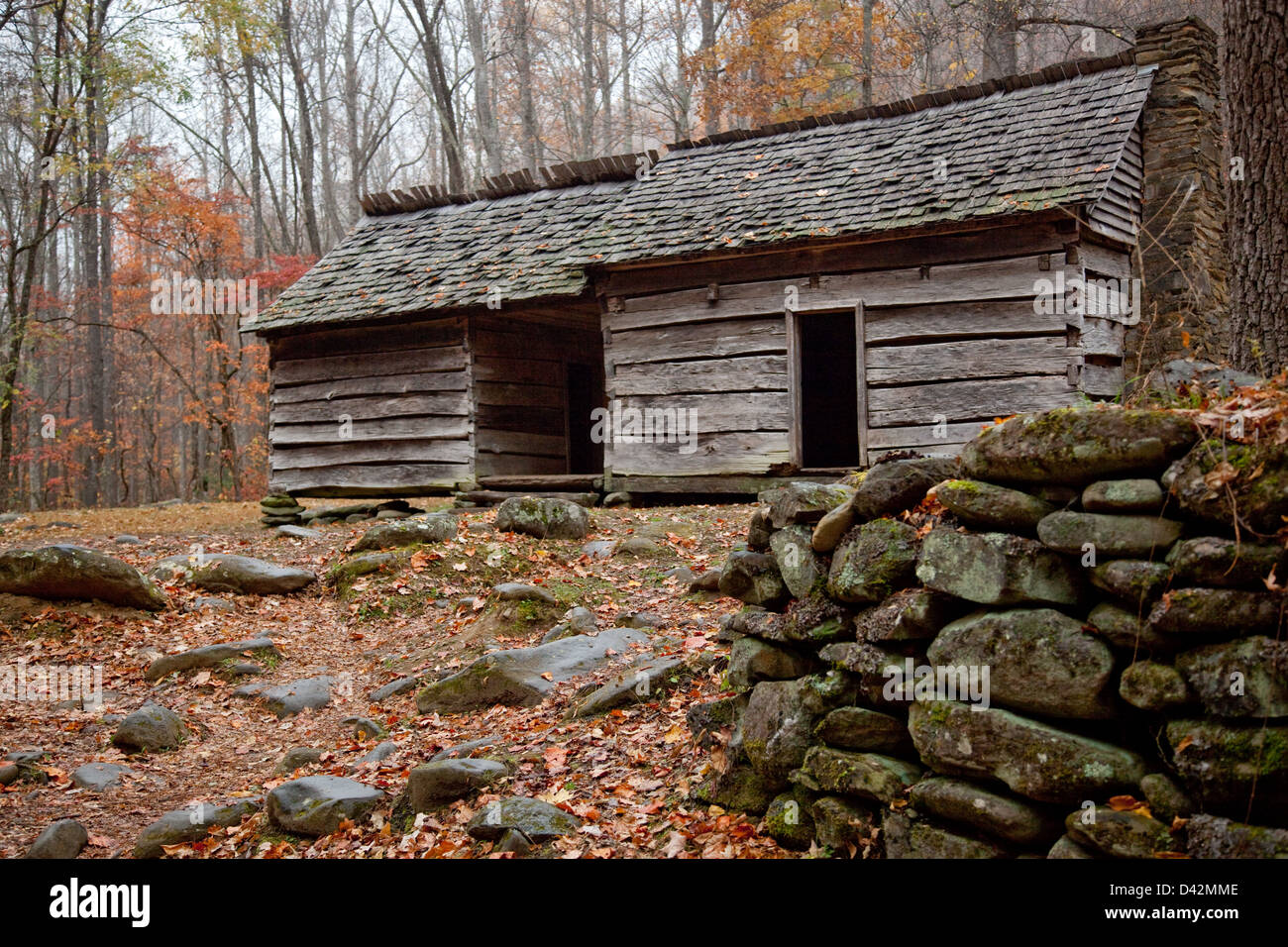 Old Rustic Log Cabin With The Fall Woods In The Background From