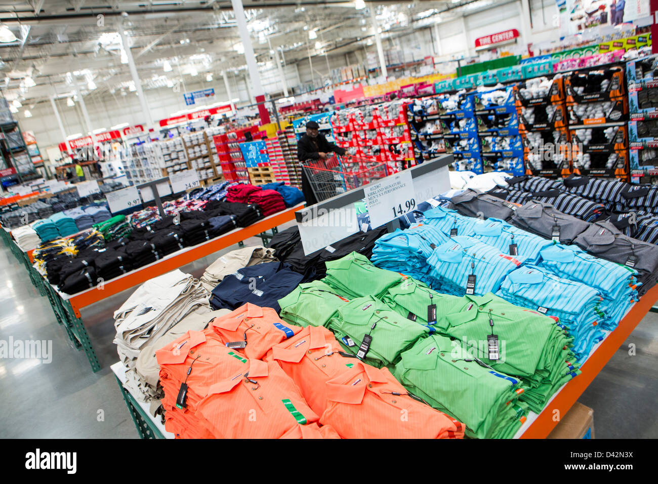 Customers shopping in the clothing section of a Costco Wholesale Warehouse Club. Stock Photo