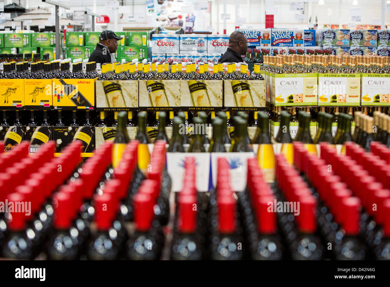 Customers shopping in the beer, wine and liquor section of a Costco