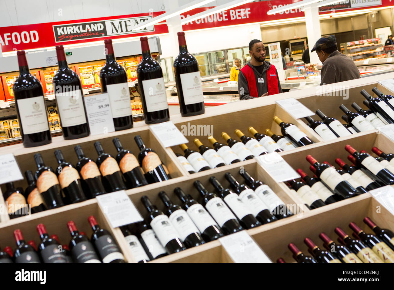 Customers shopping in the beer, wine and liquor section of a Costco