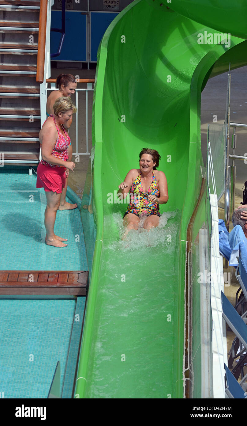 Woman on a water slide on the deck of the cruise ship Norwegian Epic Stock Photo