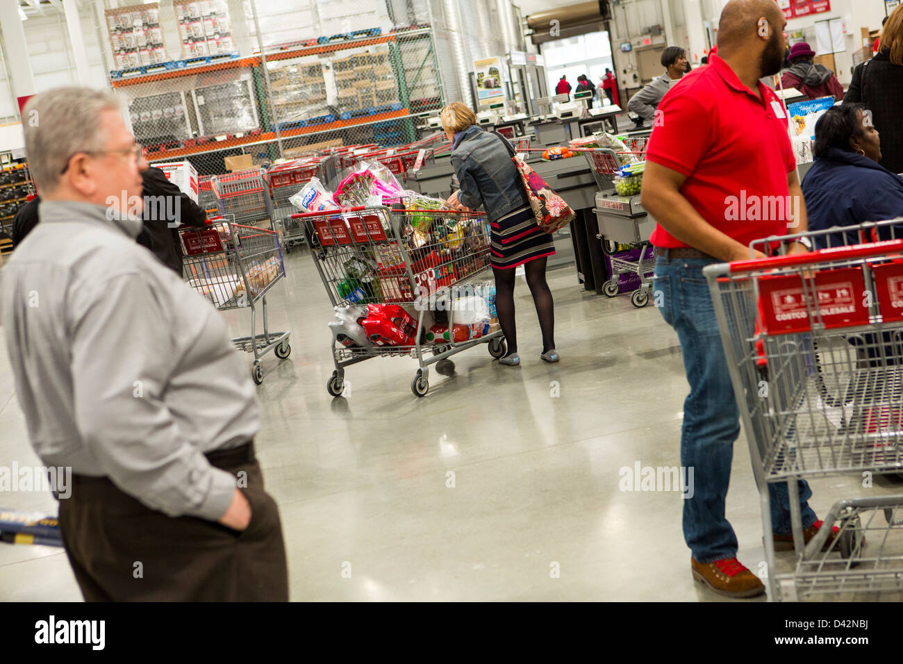 Customers at the check-out section of a Costco Wholesale Warehouse Club. Stock Photo