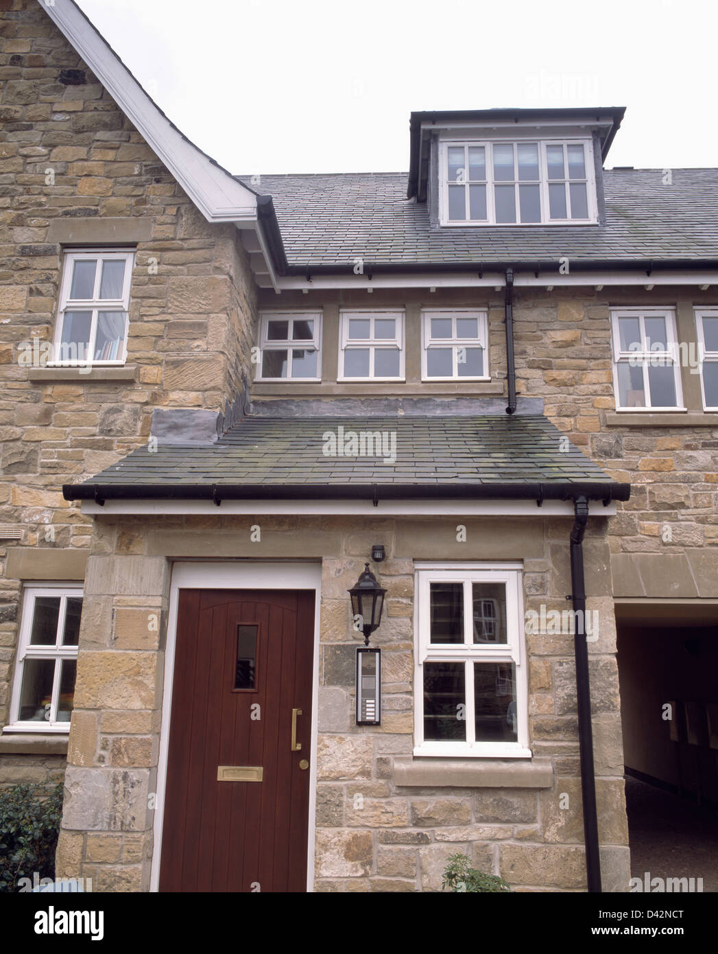 Traditional Stone House With Porch Extension And Dormer Window