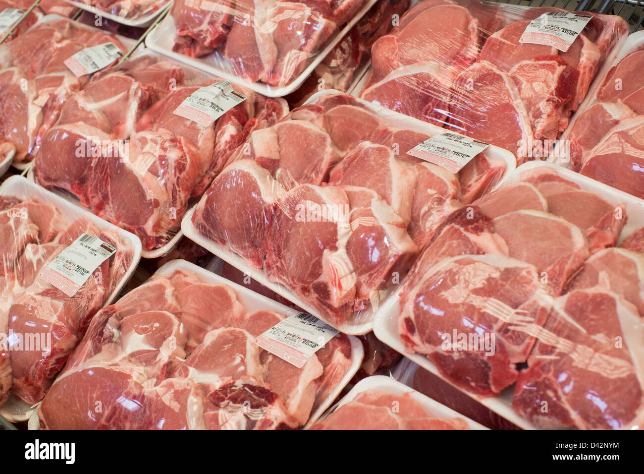 Pork products on display at a Costco Wholesale Warehouse Club. Stock Photo