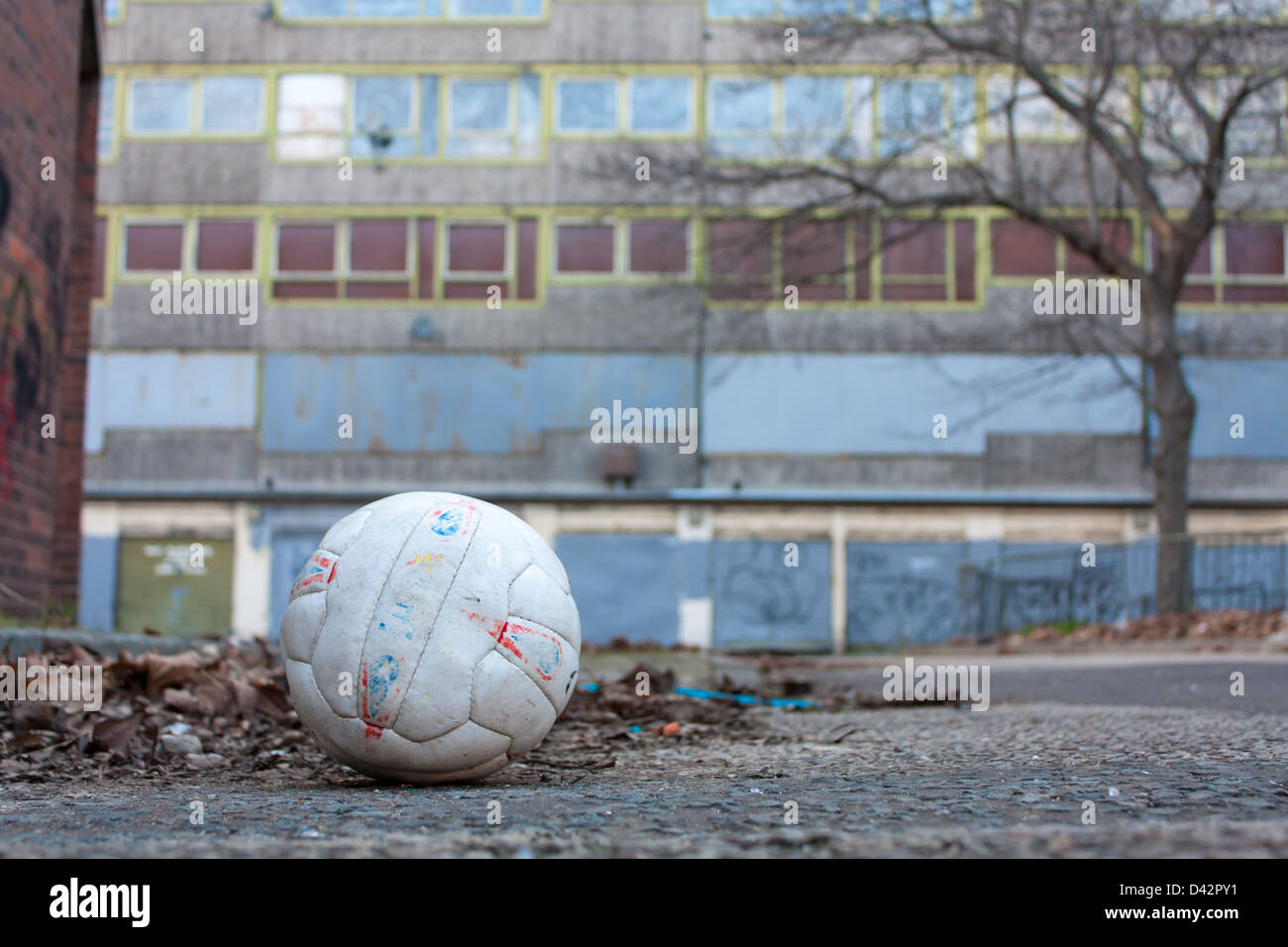 An abandoned football amid the condemned buildings of the Heygate Estate Stock Photo