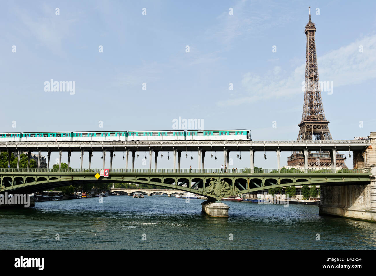 Train crossing La Seine over bridge with Eiffel Tower in the background