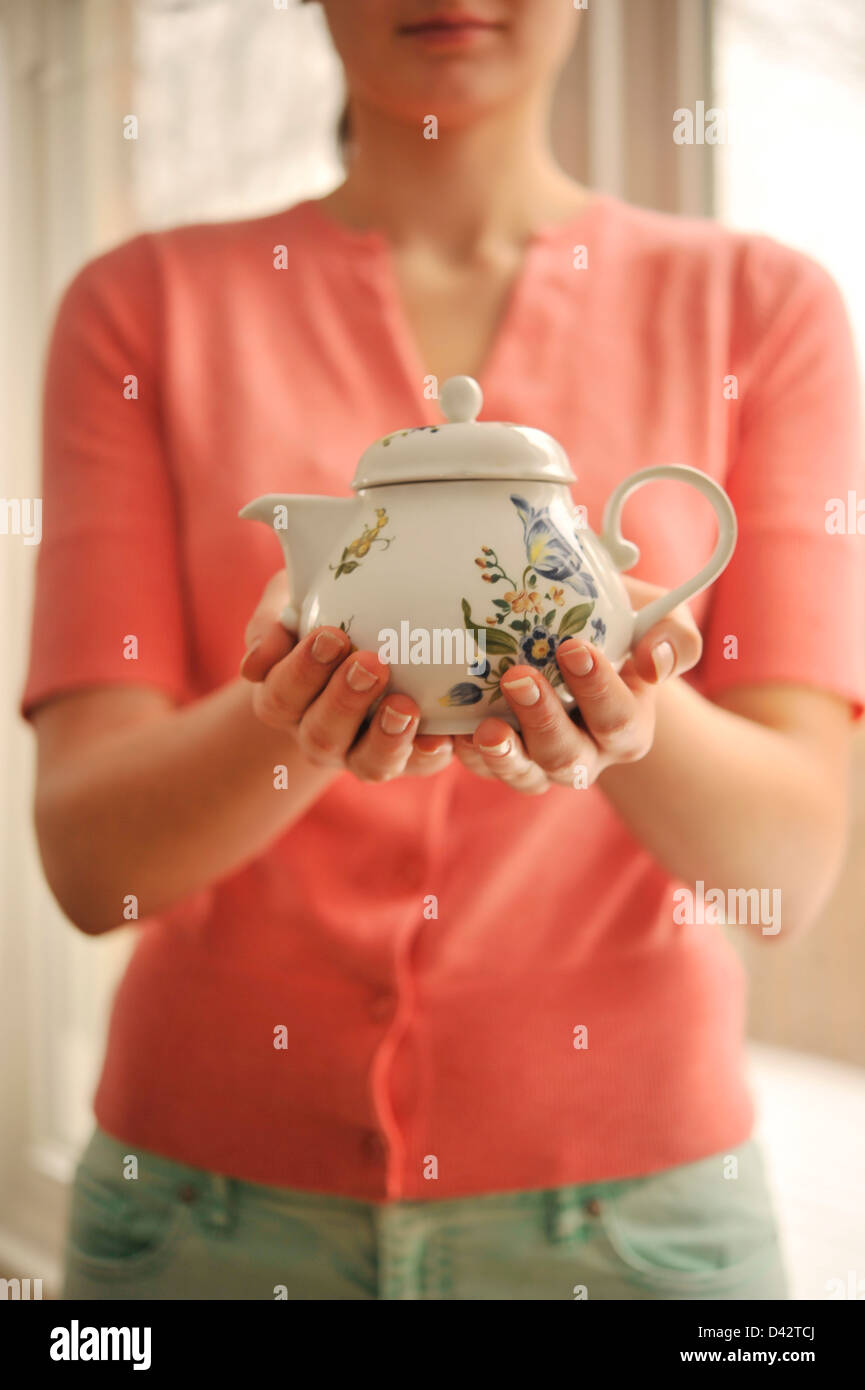 Girl holding tea pot in hi-res stock photography and images - Alamy