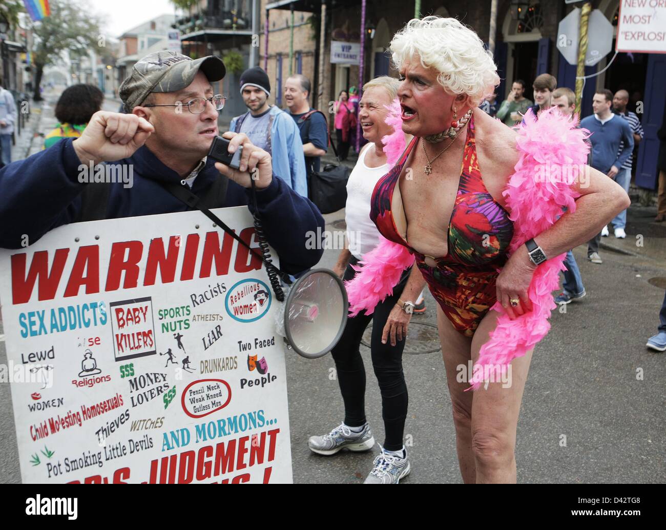 Feb. 12, 2013 - New Orleans, LOUISIANA, UNITED STATES - (left to right) A Christian Street preachers yells at a group hanging outside of a bar while drag queen Charles Loraine Wendell yells back on Bourbon Street in the French Quarter during Fat Tuesday Mardi Gras celebrations in New Orleans, Louisiana USA on February 12, 2013.  Fat Tuesday concludes the Mardi Gras celebrations throughout the Gulf Coast. (Credit Image: © Dan Anderson/ZUMAPRESS.com) Stock Photo