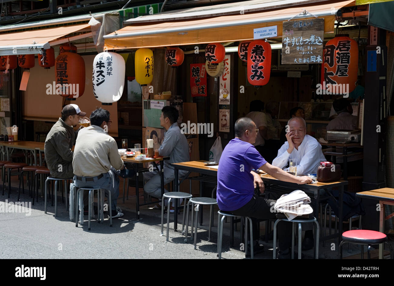 Patrons Enjoying A Beer Or Two At A Street Side Izakaya Or Casual Drinking Establishment In The Working Class Neighborhood Stock Photo Alamy