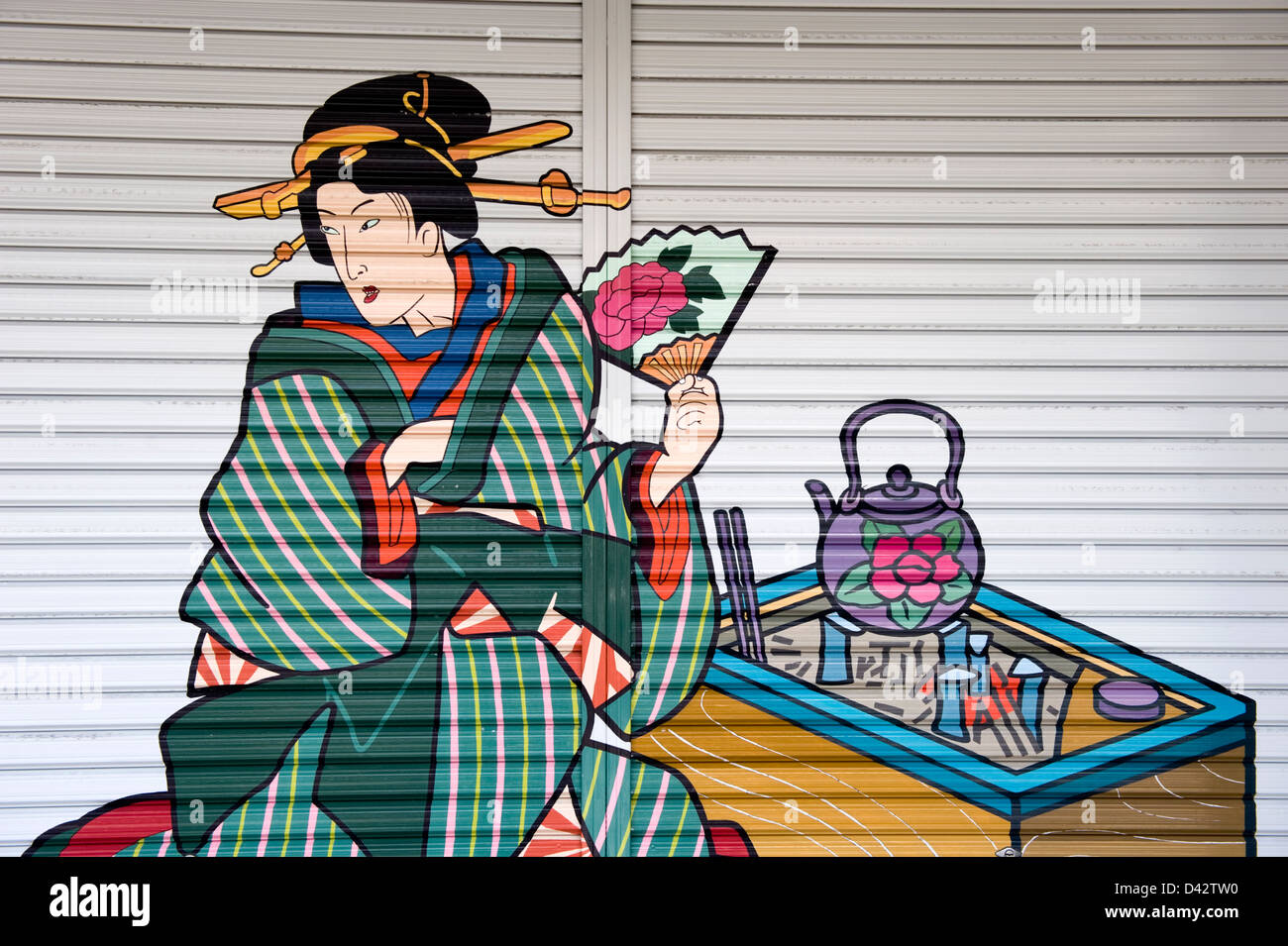 Traditional Ukiyo-e style painted artwork adorns a retail shop shutter in the old entertainment district of Asakusa, Tokyo. Stock Photo