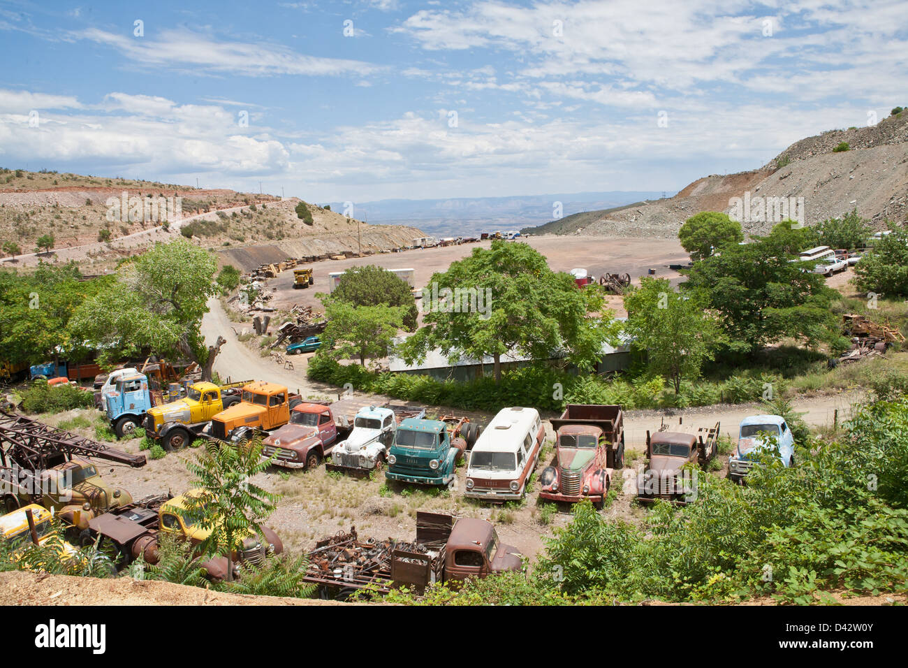 An old vehicle and automobile junk yard in the middle of a desert. Stock Photo