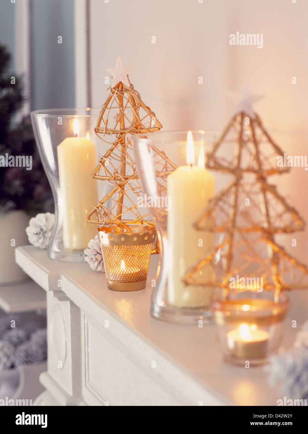 Close Up Of Glass Vases With Lighted Candles On Mantelpiece With