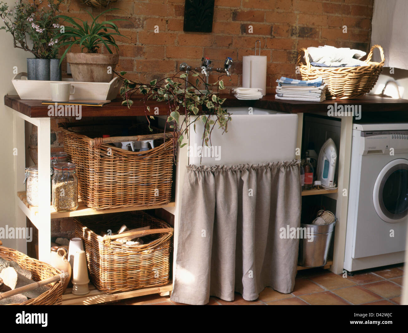 Storage Baskets On Shelf Unit Beside Belfast Sink In Unit