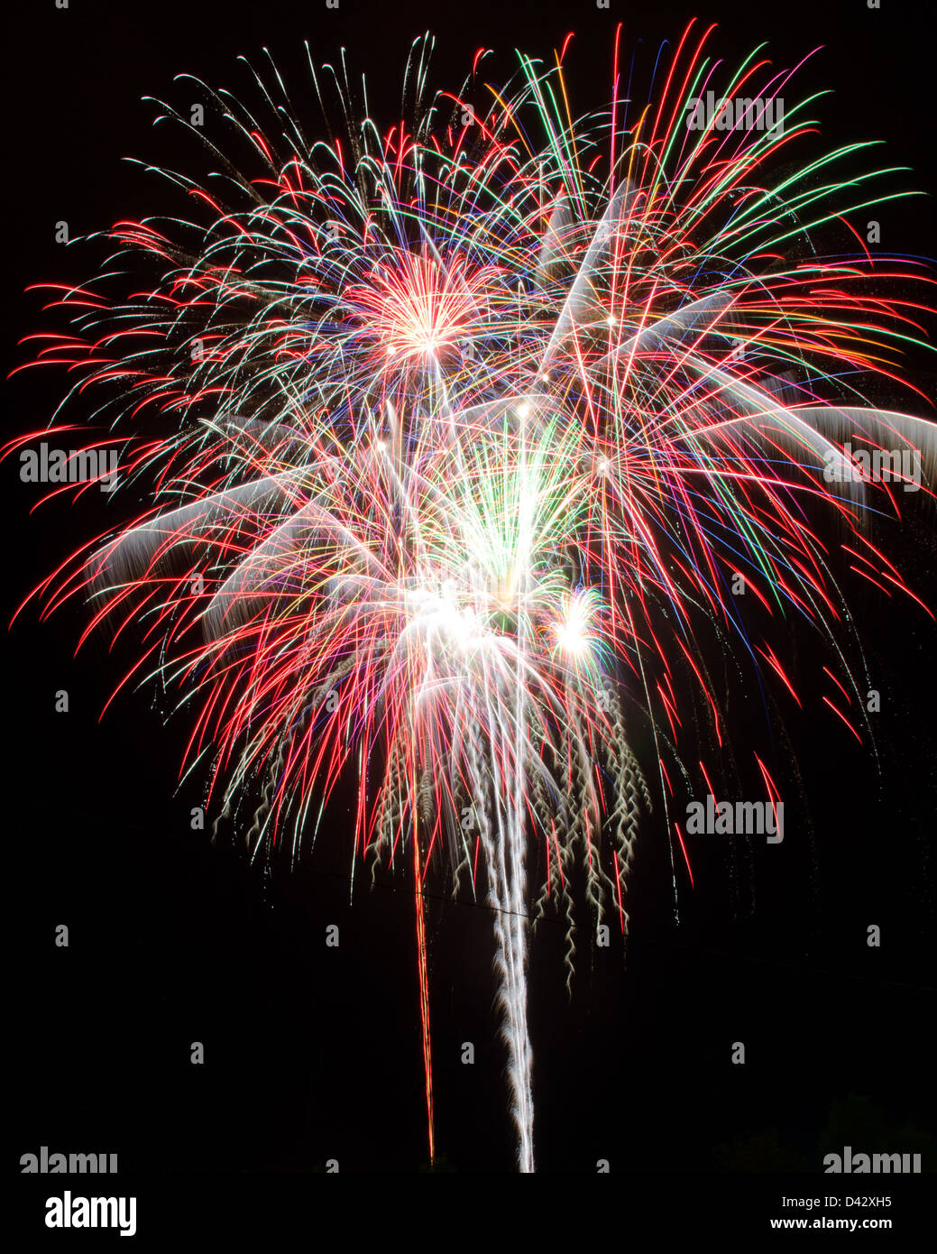 Fireworks explode in red, green, blue and white clusters at the Blue Hill Fair, Maine. Stock Photo