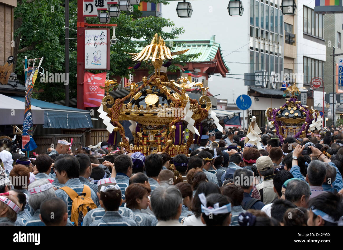 People carry a gold decorated sacred mikoshi portable shrine in the Sanja Matsuri Festival, one of Tokyo's big three events. Stock Photo
