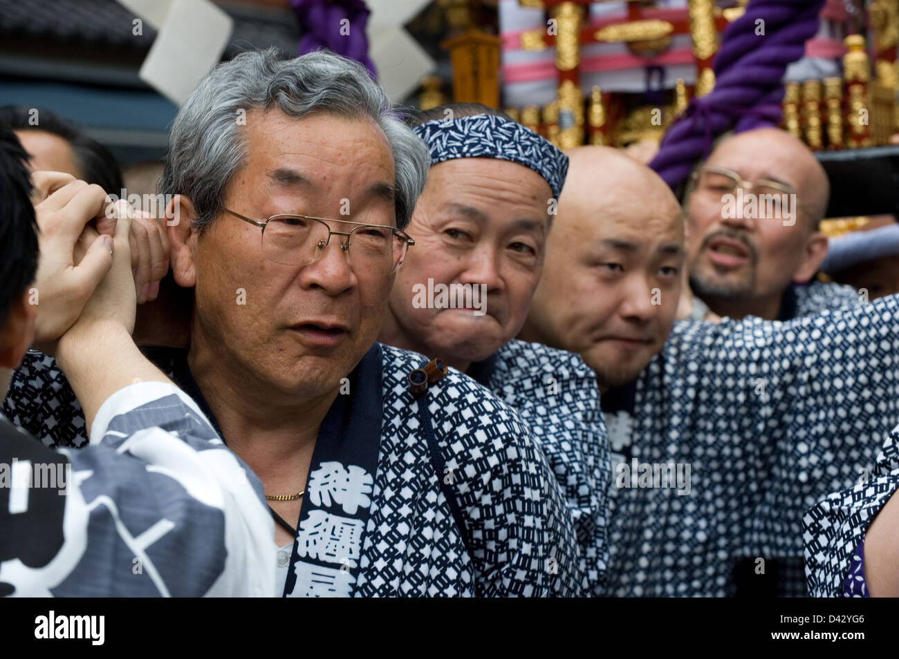 Men carry a gold decorated sacred mikoshi portable shrine in the Sanja Matsuri Festival, one of Tokyo's big three events. Stock Photo