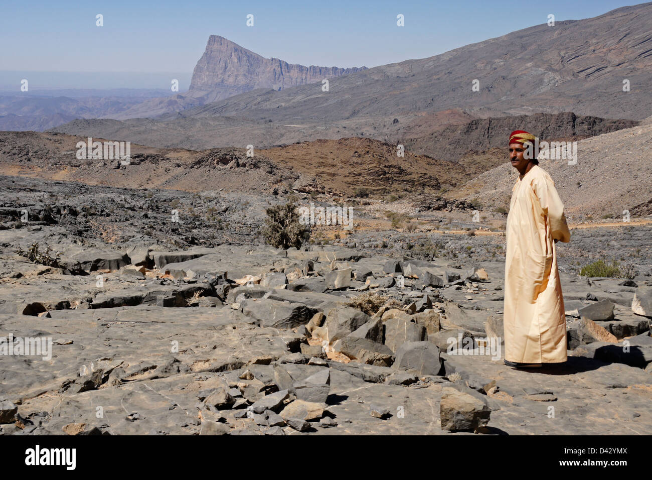 Omani man with Jebel Misht in background, Oman Stock Photo