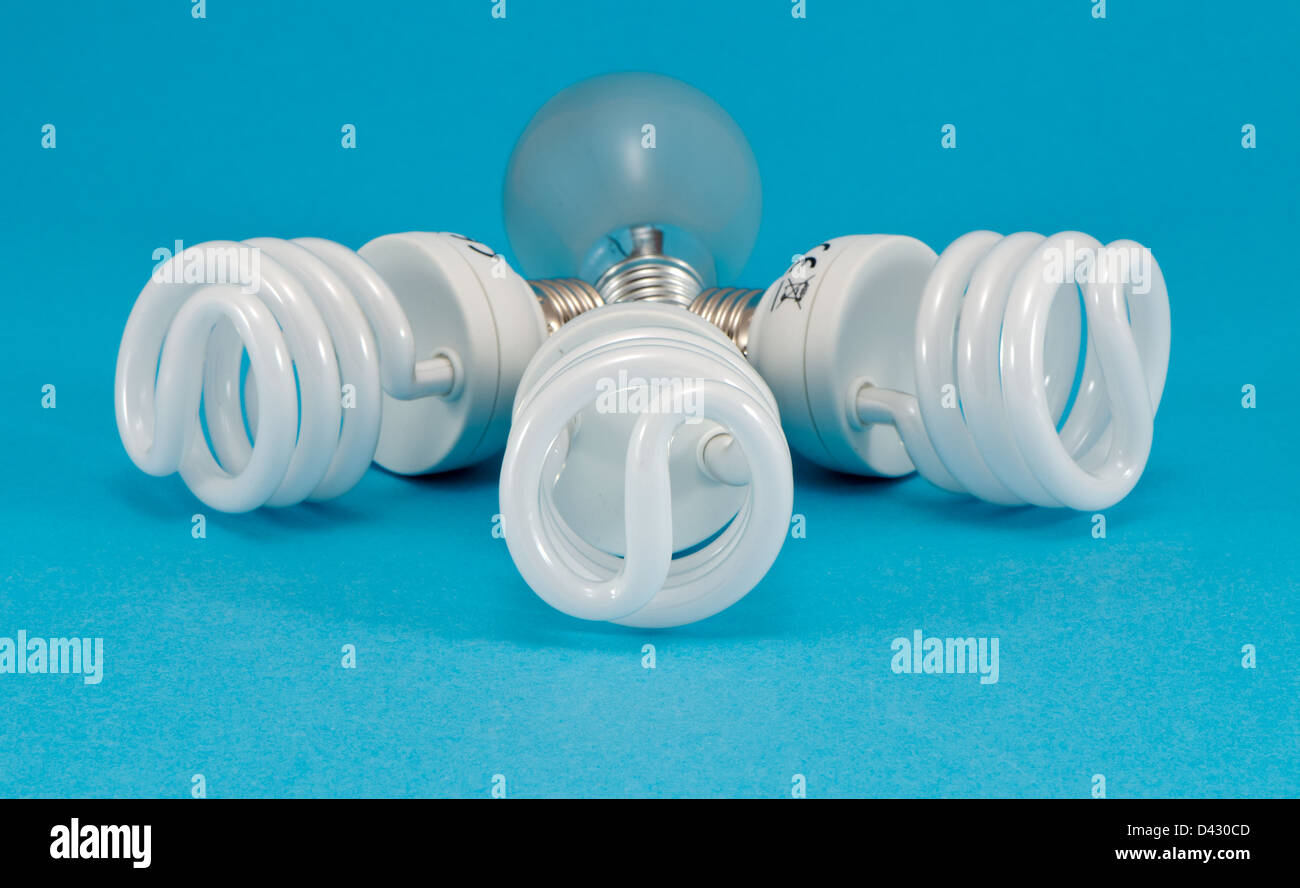 novel new modern fluorescent lights and old incandescent heat bulb on