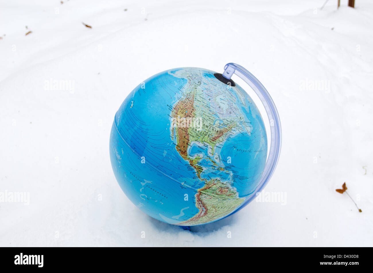 earth globe sphere lie stand in winter snow snowbank. Stock Photo