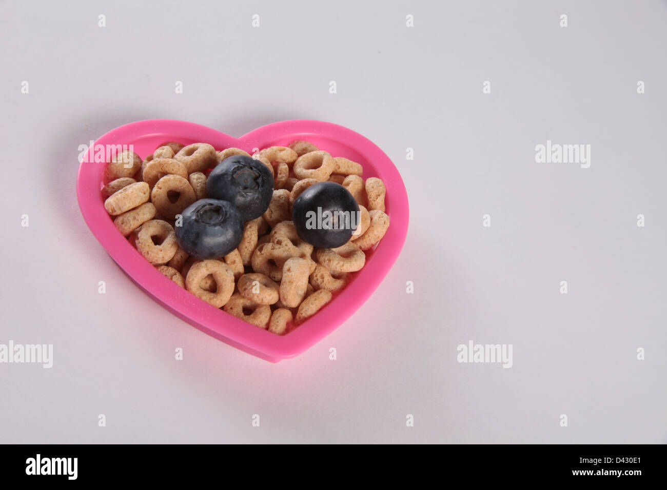Fresh blueberry on top of cereals...A heart healthy cereal and blueberry will gratefully reduce cholesterol and heart disease . Stock Photo