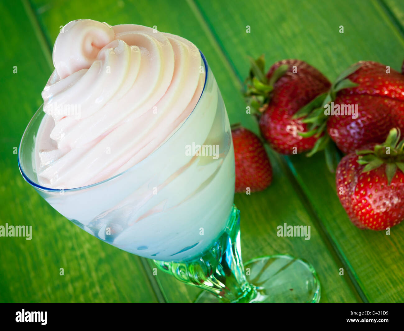 Cup of strawberry frozen yogurt or soft serve ice cream with fresh