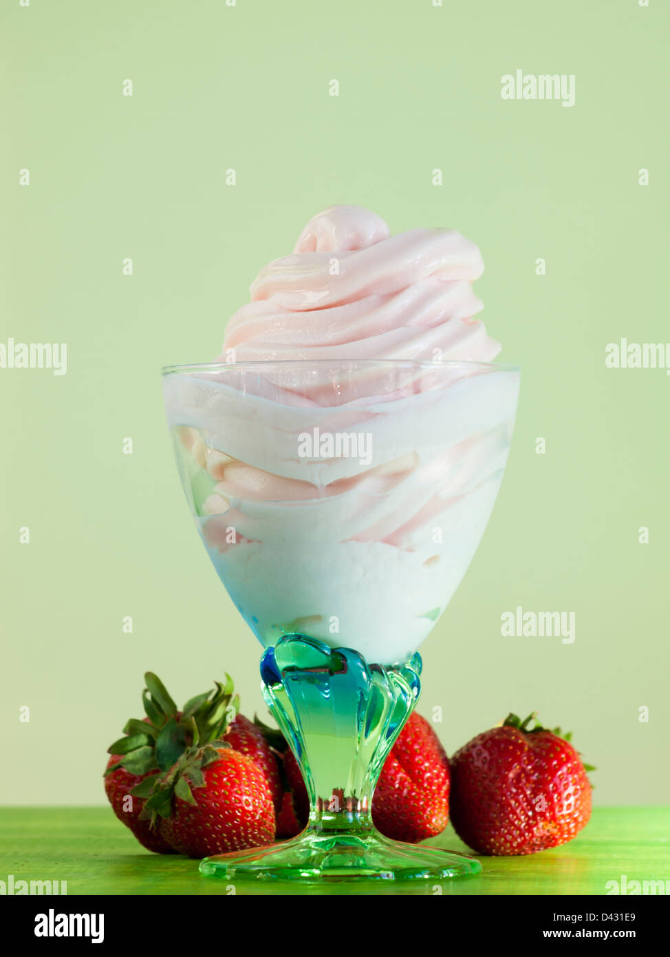 Cup of strawberry frozen yogurt or soft serve ice cream with fresh