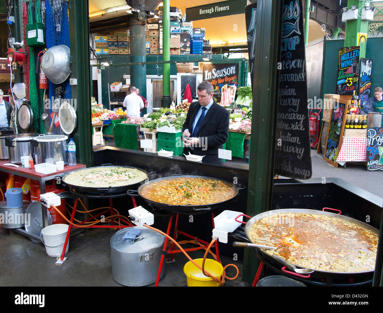 Street food - curries in large woks - for sale in Borough Market, London Stock Photo