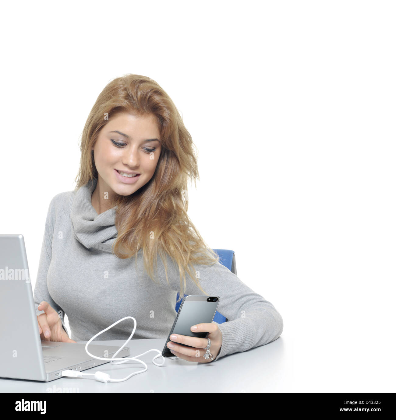 Woman with the laptop and mobile phones sand message Stock Photo