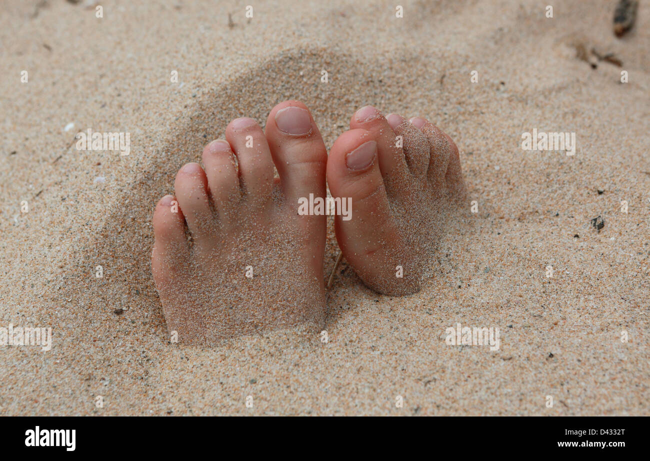Santa Margherita di Pula, Italy, feet buried in the sand Stock Photo