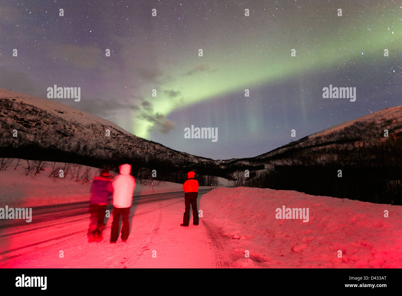 tourists watching northern lights aurora borealis near tromso in ...
