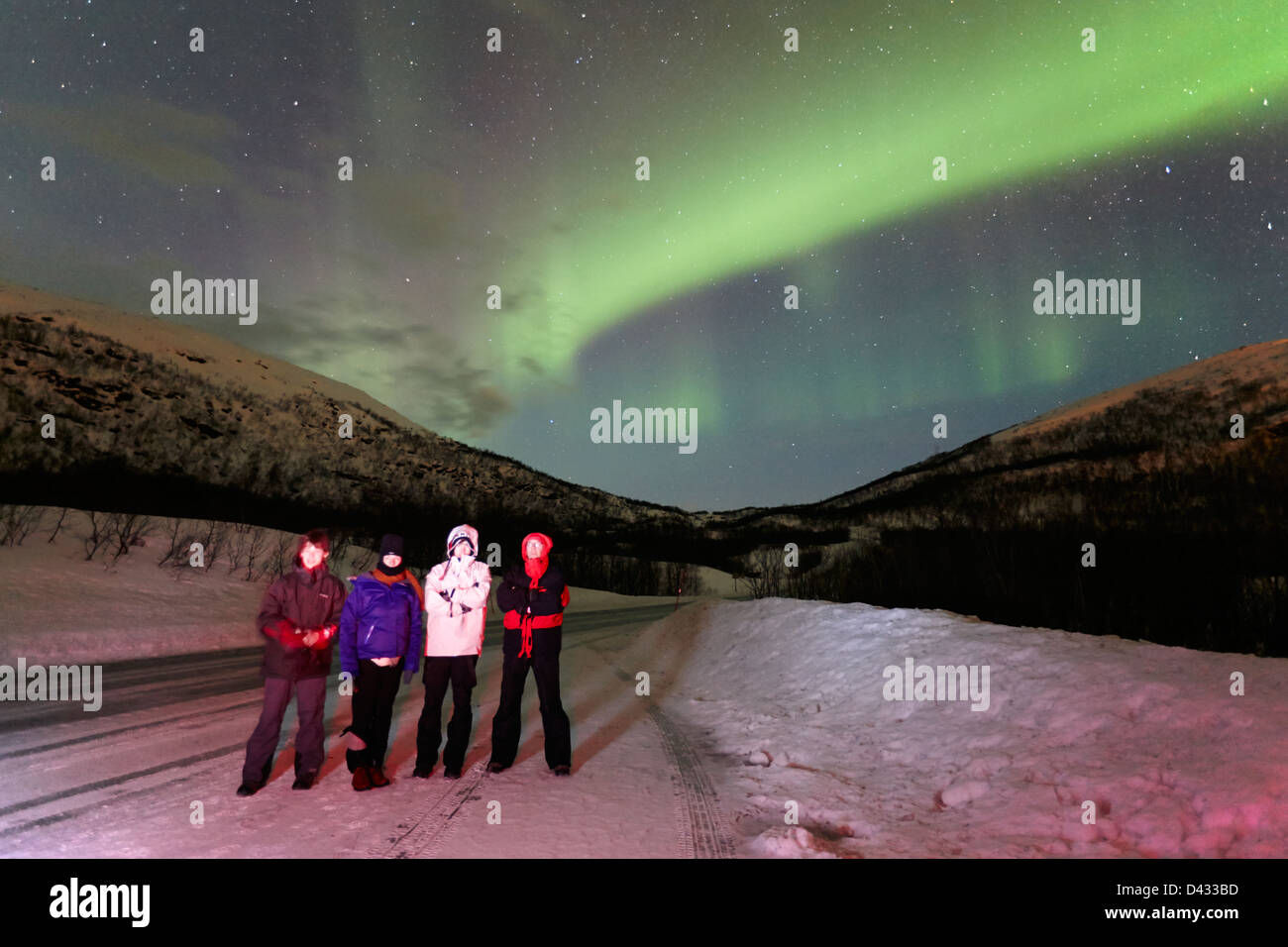 tourists watching northern lights aurora borealis near tromso in ...