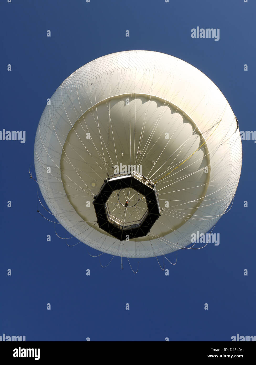 White hot air balloon rising up in the air Stock Photo