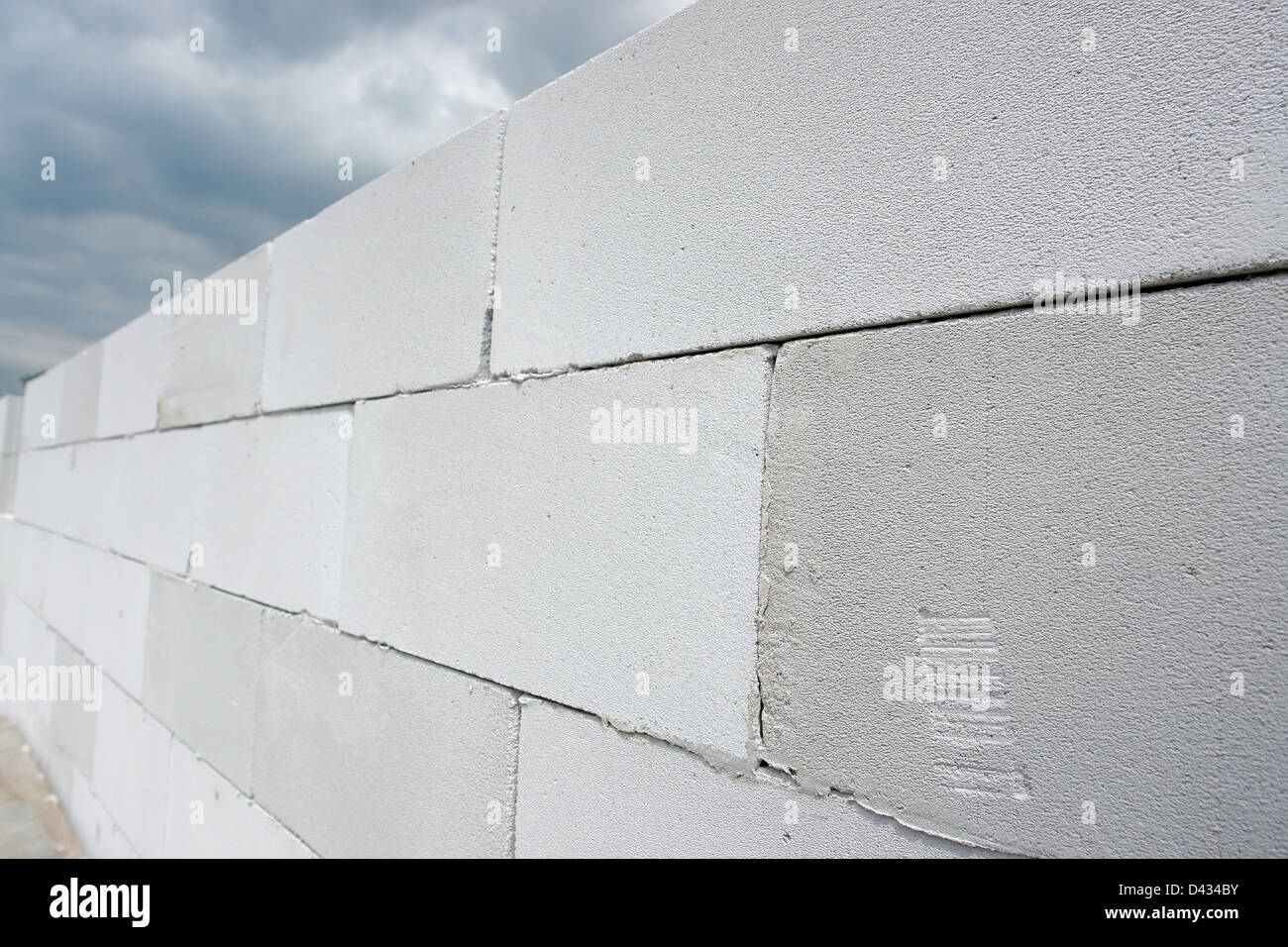 Unfinished house wall made from white aerated autoclaved concrete blocks Stock Photo