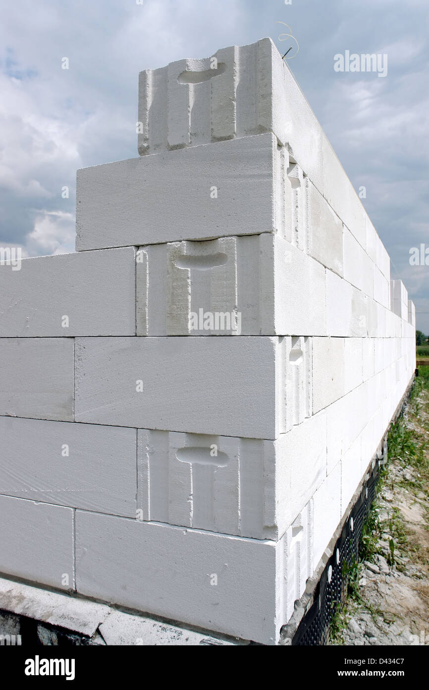 Unfinished house wall made from white aerated autoclaved concrete blocks Stock Photo