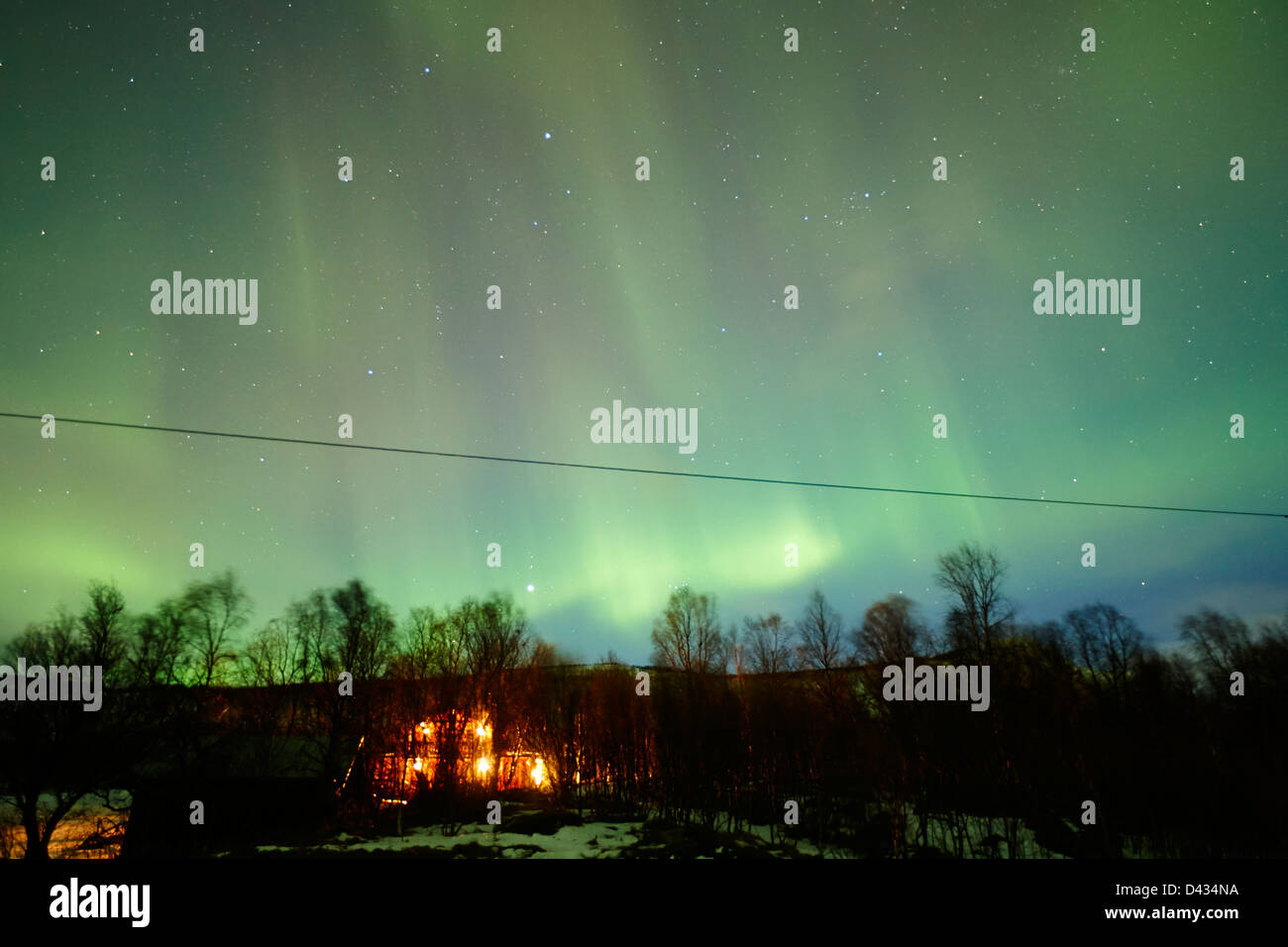 rural house with full sky canopy of northern lights aurora borealis near tromso in northern norway europe Stock Photo