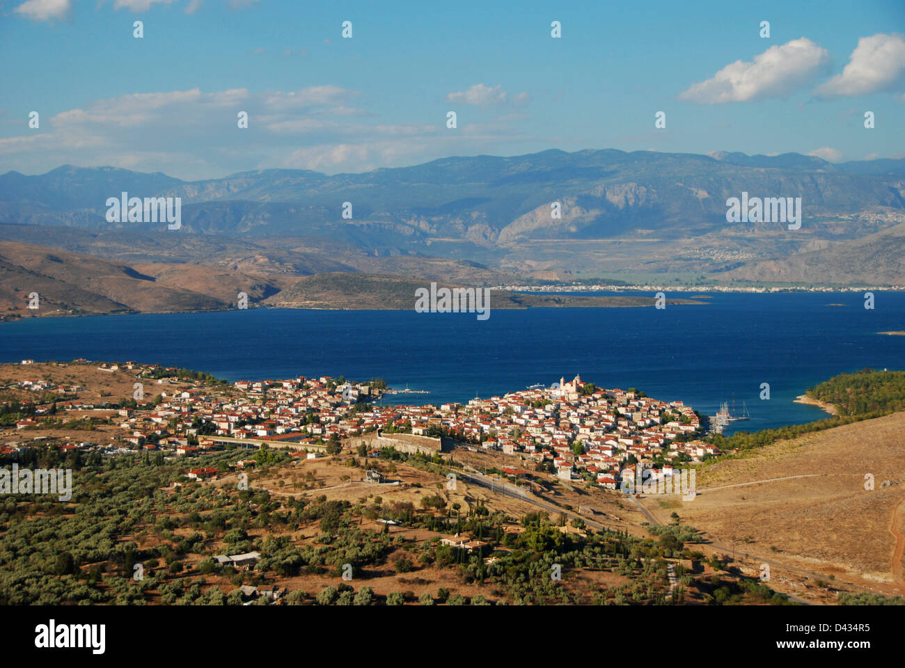 The Greek coastal town of Galaxidi seen from behind, with Itea in the distance across the sea Stock Photo