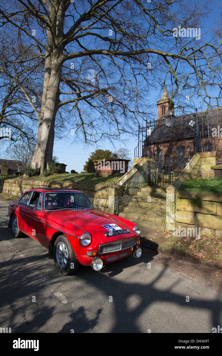 Village of Coddington, England. Picturesque sunny view of a 1970 MGB GT