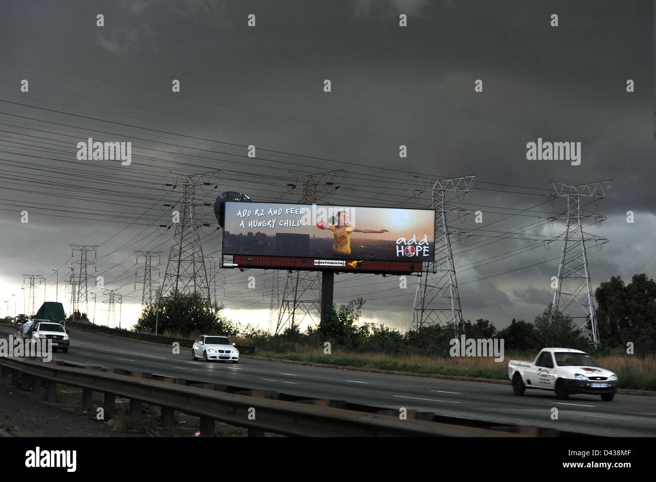 A Democratic Alliance political billboard on the side of a South African road with storm clouds in the background. Stock Photo