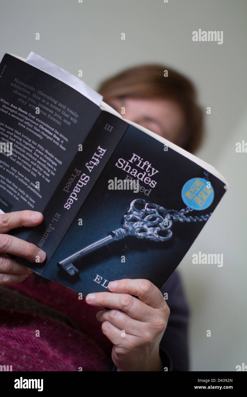 Woman Reading Fifty Shades Freed Book By E L James Part Of The Erotic Literature Fifty Shades Of Grey Trilogy Stock Photo Alamy