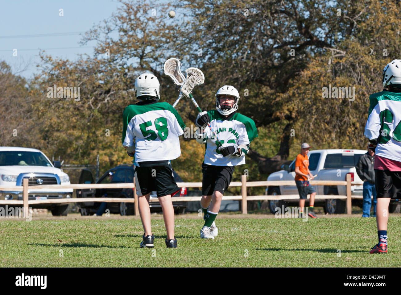 American youth Lacrosse players in team uniforms with lacrosse sticks