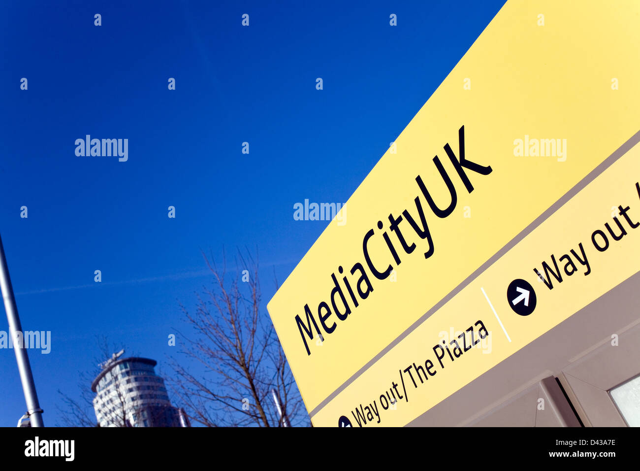 MediaCityUK Tram Sign Against a Bright Blue Sky Stock Photo