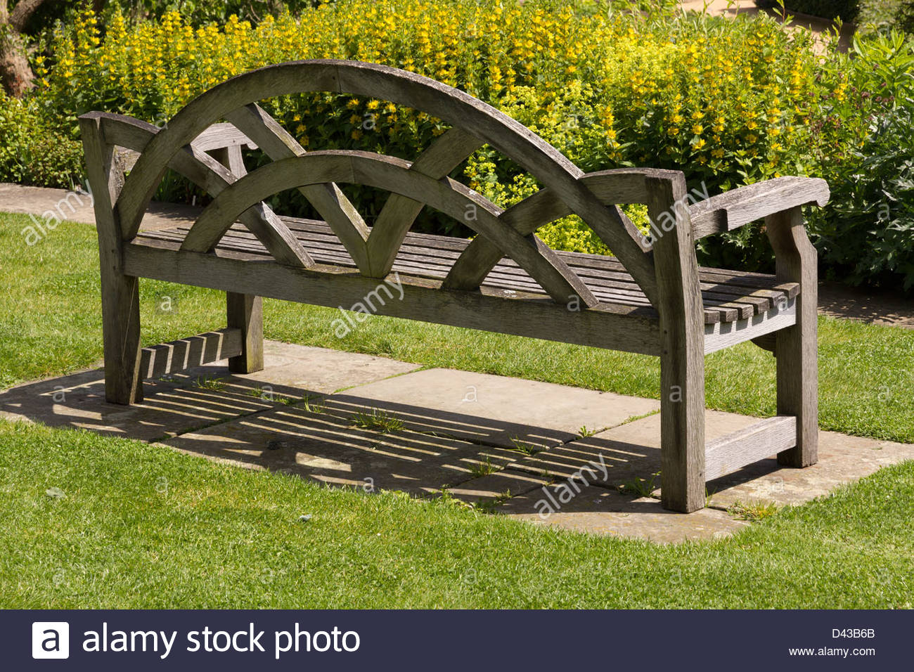 Ornate Oak Garden Bench Seat On Green Grass Lawn England Uk
