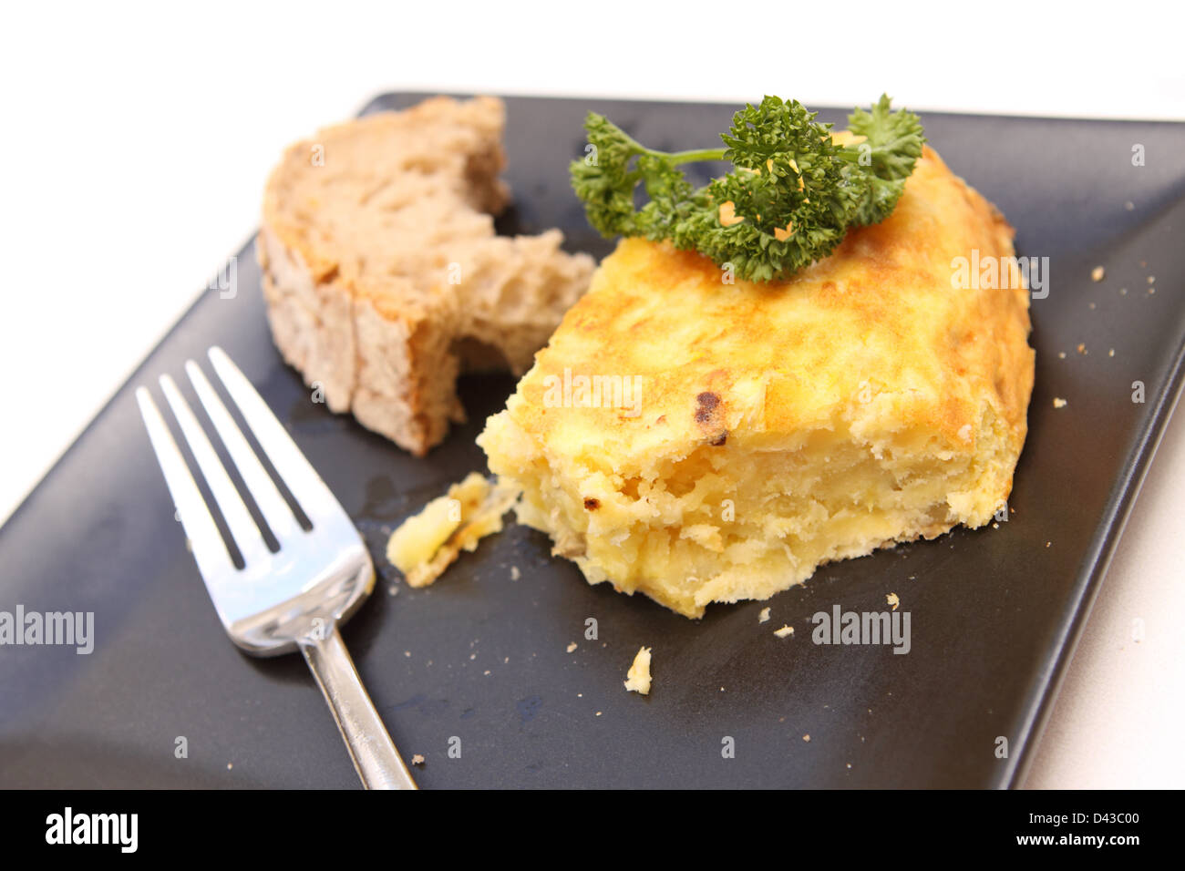 Spain Spanish Omelette made of potato and egg and onion served with parsley and bread Madrid Spain Stock Photo